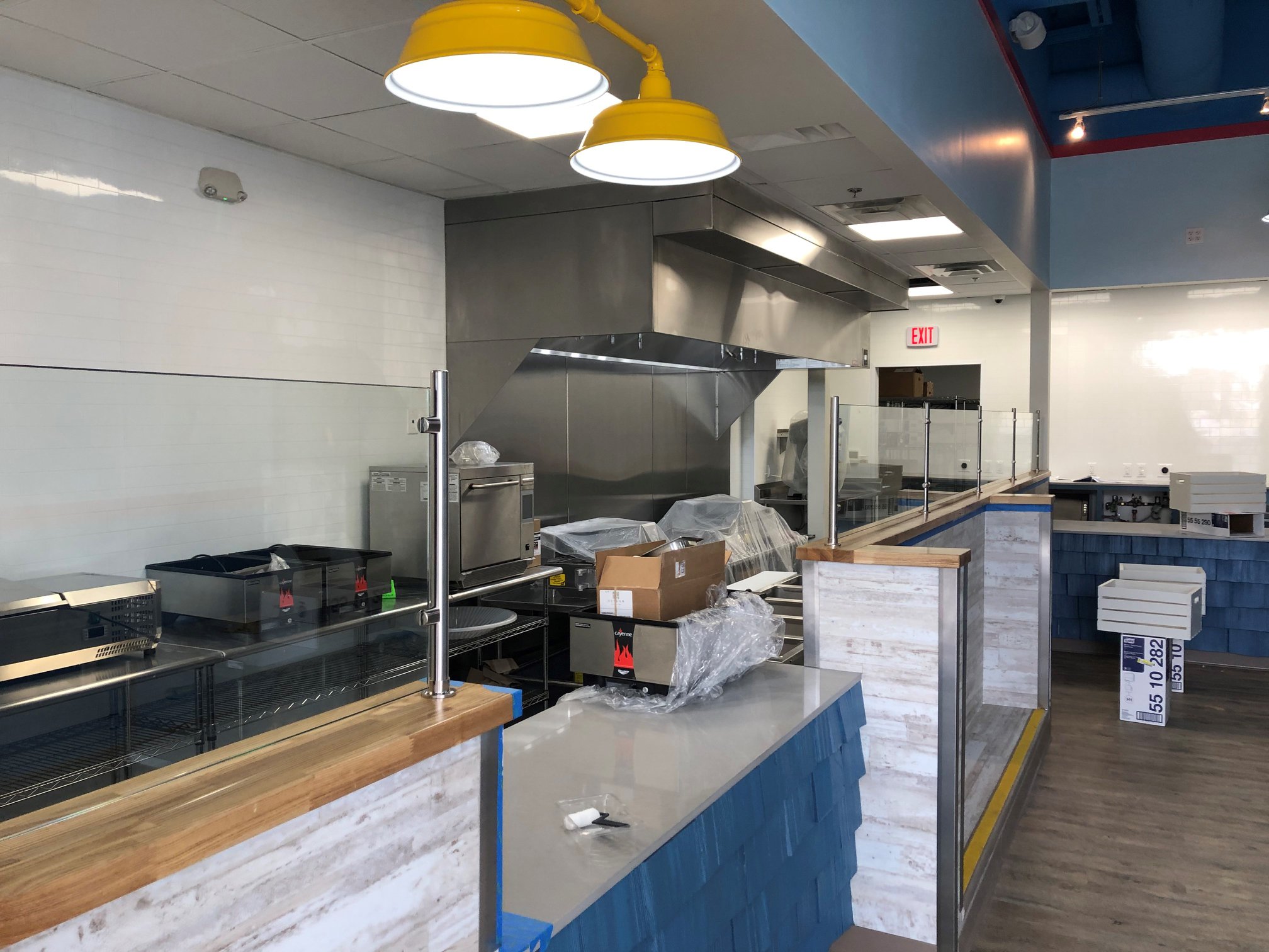 Donut shop kitchen remodel with blue and white customer counters. 